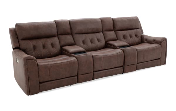 Brown leather reclining sectional sofa with quilted backrests, padded armrests, and built-in center console storage compartments.