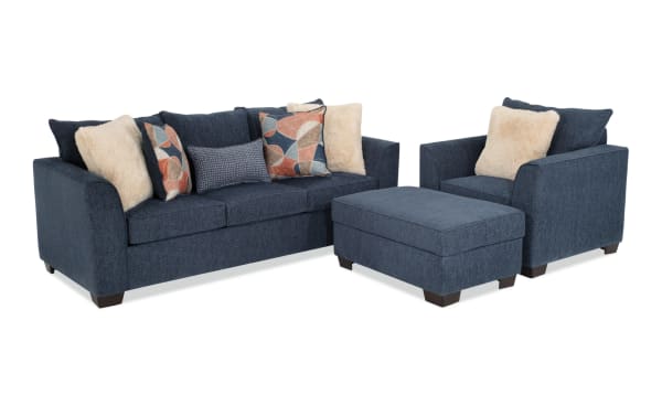 Brynn Navy 88'' transitional living room set with navy polyester fabric sofa, chair, and storage ottoman featuring Bob-O-Pedic memory foam cushions and assorted accent pillows.