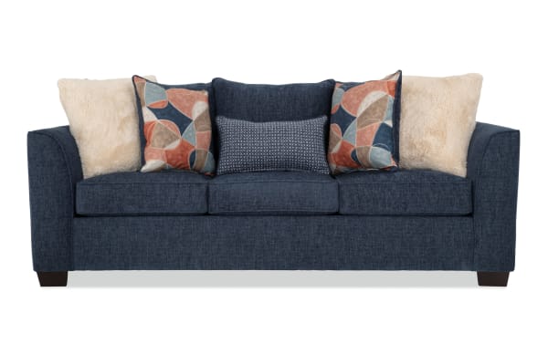Brynn Navy 88'' transitional sofa in soft navy blue polyester fabric with Bob-O-Pedic memory foam cushions and mixed patterned and plush accent pillows.