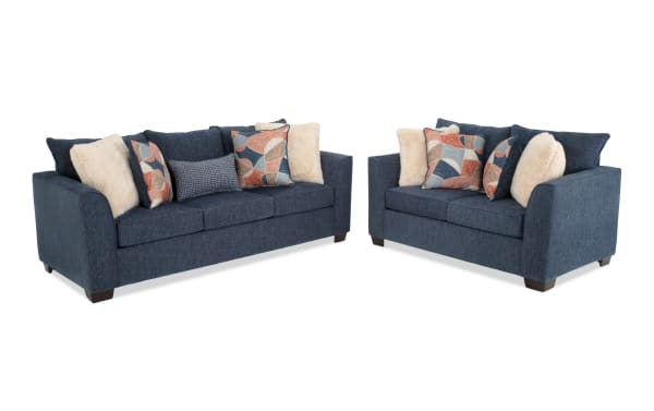 Brynn Navy transitional living room set featuring an 88'' sleeper sofa with queen gel memory foam mattress and 64'' loveseat. Upholstered in soft navy polyester fabric with Bob-O-Pedic cushions and multiple decorative accent pillows.