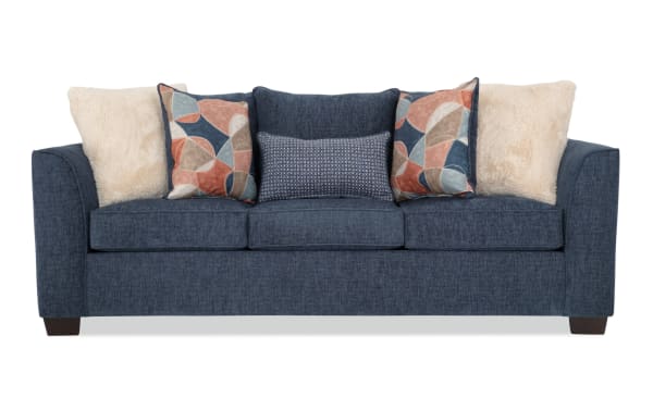Brynn Navy 91'' transitional sleeper sofa in soft polyester fabric with Bob-O-Pedic memory foam cushions, blue upholstery, and mixed patterned accent pillows.