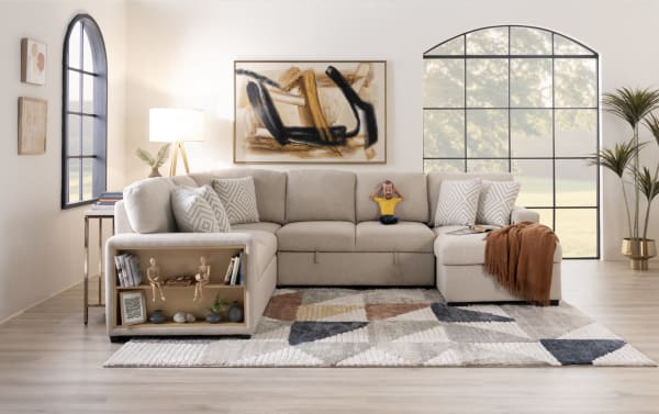 Playday Gray 119'' 4 Piece Right Arm Facing Pop-Up Sleeper Chaise Sectional in gray polyester fabric with built-in bookshelf, storage chaise, USB/USB-C ports, memory foam cushions, accent pillows, and drop-down table with cupholders, styled in transitional design.