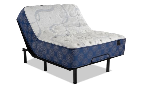 Power Bob Essential Base with Indulgence 15'' Queen Plush Mattress featuring blue patterned sides, white quilted top, adjustable black metal base with wired remote and height-adjustable legs.