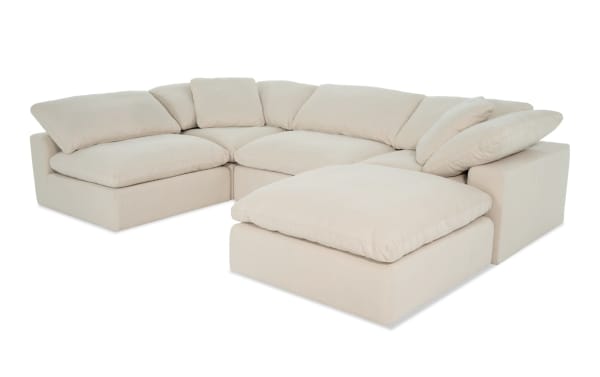 Beige Dream Shell 131'' 5 Piece Modular Sectional with 2 armless chairs, 2 corners, and 1 ottoman in transitional style. Fabric upholstery with reversible, oversized cushions.