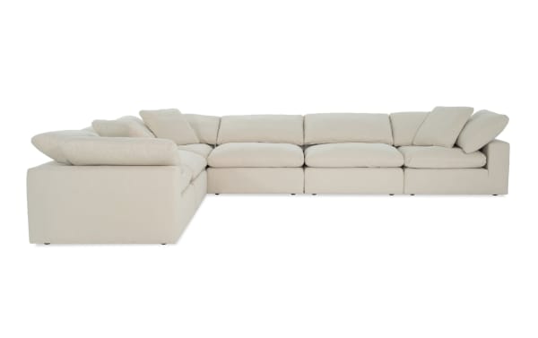 Beige Dream Shell 174" 6-piece modular sectional sofa with 3 armless chairs and 3 corner units, featuring reversible oversized cushions in soft polyester-nylon fabric. Transitional style living room seating with cozy feather blend toppers and jersey knit-like upholstery for customizable comfort.