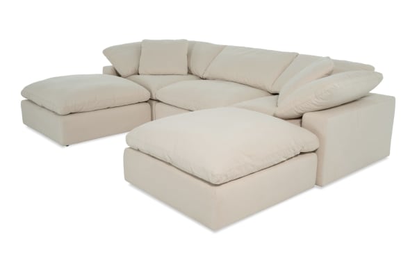 Dream Shell 131'' beige 5-piece modular sectional with 2 corners, 2 ottomans, 1 armless chair in transitional style. Polyester fabric upholstery with oversized reversible cushions and feather blend toppers for customizable living room seating.