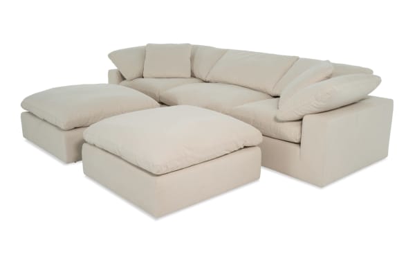 Beige Dream Shell 131'' 5 Piece Modular Sectional with 2 corners, 2 ottomans, 1 armless chair in transitional style. Polyester fabric upholstery with oversized reversible cushions and feather blend toppers for customizable living room seating.
