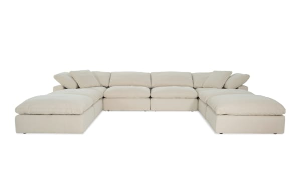 Dream Shell 174'' 8-piece beige modular sectional with 4 ottomans, 2 armless chairs, 2 corners in transitional style. Polyester fabric upholstery with oversized reversible cushions and feather blend toppers. Customizable Dream collection seating for versatile living room layouts.
