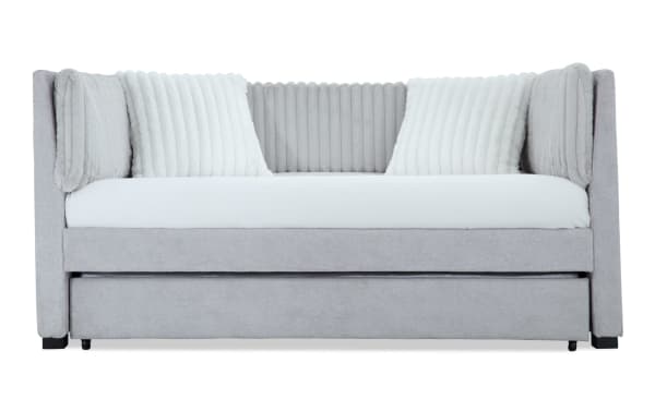 Sofia Twin Gray Upholstered Daybed with Twin Trundle in gray polyester fabric, featuring channel tufted back cushions and two faux fur pillows in glam style.
