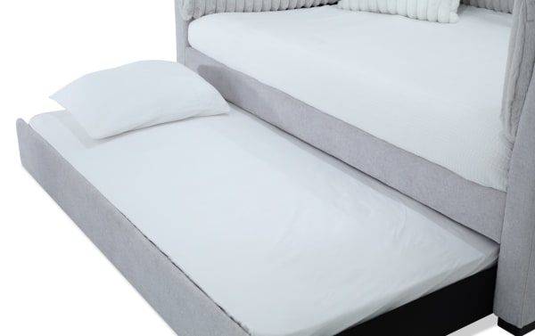 Sofia Twin Gray Upholstered Daybed with Twin Trundle in gray polyester fabric, glam style with channel tufted back cushions and faux fur pillows, includes pull-out trundle bed for extra sleeping space.