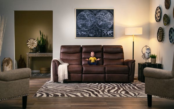 Transitional Forte Chocolate 82" power reclining sofa in brown polyester fabric with padded arms, memory foam seating, USB port, and contrasting stitch design.