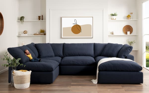 Dream Navy 131'' 5 Piece Modular Sectional in navy blue fabric with oversized reversible cushions, transitional style, polyester-nylon blend upholstery.