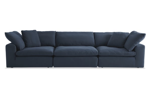 Dream Navy 131'' 3 Piece Modular Sofa with 2 Corners and 1 Armless Chair, transitional style in navy blue polyester-nylon fabric with oversized reversible cushions and feather blend pillows.