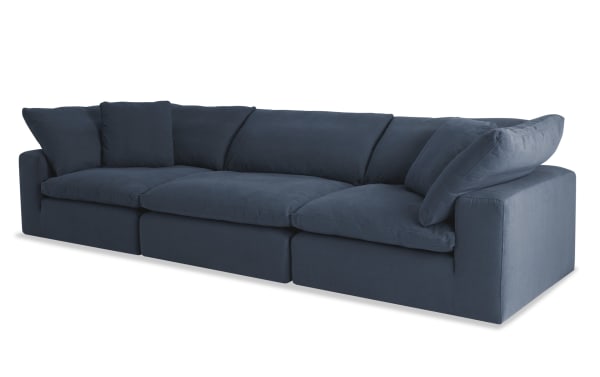 Dream Navy 131'' 3 Piece Modular Sofa in navy blue fabric with two corners and one armless chair, featuring oversized reversible cushions and feather blend pillows. Transitional style, polyester and nylon upholstery for customizable living room seating.