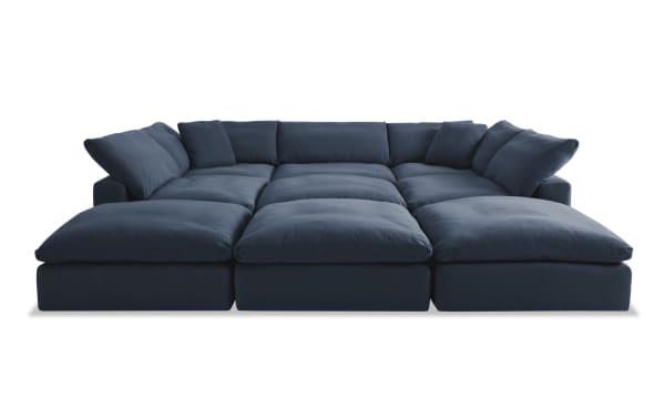 Dream Navy 131'' 9 Piece Modular Sectional in navy blue fabric with 4 ottomans, 3 armless chairs, 2 corners, oversized reversible cushions, and transitional style.
