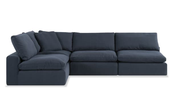 Dream Navy 173'' 4 Piece Modular Sectional in navy blue fabric, transitional style with polyester and nylon upholstery. Features 3 armless chairs and 1 corner piece with oversized reversible cushions and feather blend toppers for customizable living room seating.