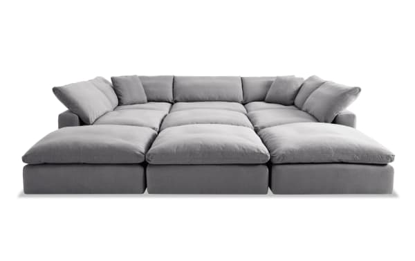 Dream Gray 131'' 9 Piece Modular Sectional with 4 ottomans, 3 armless chairs, 2 corners in gray polyester fabric. Transitional style with oversized reversible cushions and feather blend toppers for customizable living room seating.