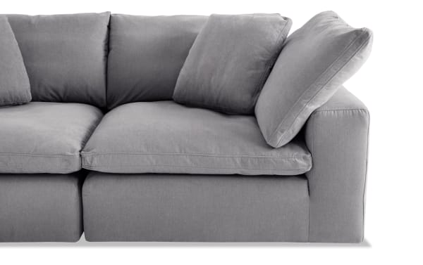 Dream Gray 131'' 6 Piece Modular Sectional in gray polyester fabric with reversible oversized cushions, transitional style, and plush feather blend topper.
