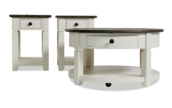 Laurel White & Brown Round Storage Coffee and 2 Chairside Table Set from Laurel Entertainment & Occasional collection, farmhouse style MDF wood with two-tone distressed tops, dark hardware, and built-in storage drawers for living room organization.