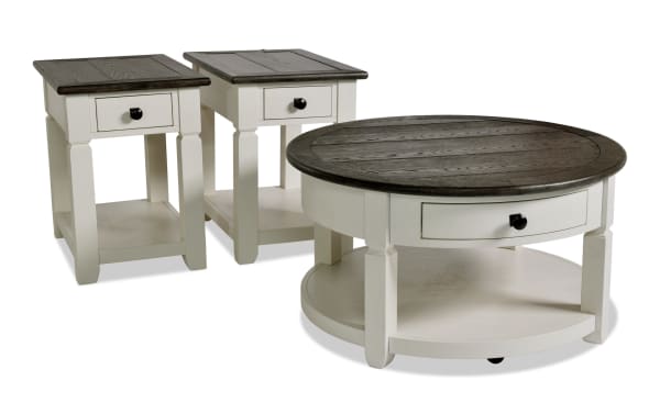 Laurel White & Brown Round Storage Coffee Table and 2 Chairside Tables set in farmhouse style, MDF with two-tone distressed wood tops, drawers, and lower shelves for storage.