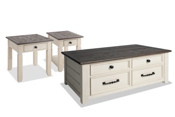 Laurel Entertainment & Occasional cottage-style coffee and end table set in white and brown MDF, rubberwood, and acacia veneers with lift-top storage, distressed tops, dark hardware, and casters for mobility.