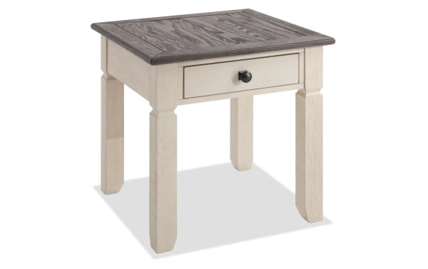 Laurel White & Brown Cottage Style End Table with MDF, Rubberwood, Acacia Veneers, distressed two-tone wood finish, and a black knob drawer.