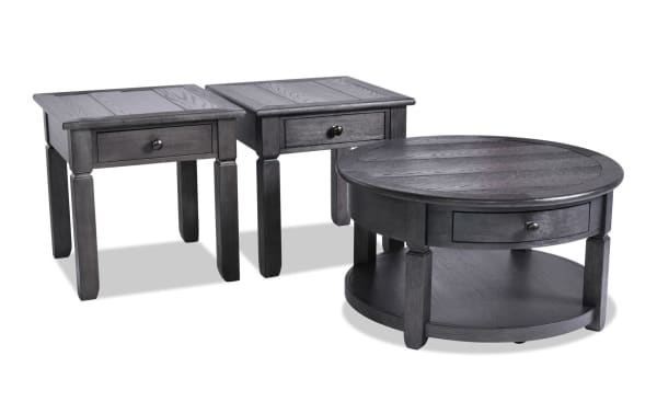 Laurel 3 Piece Charcoal Round Storage Coffee & 2 End Table Set with MDF wood, farmhouse style, dark charcoal finish, storage drawers, and distressed tops.