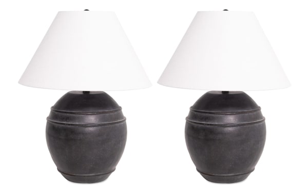 Set of 2 Laurel Charcoal Table Lamps with round gray ceramic bases and white fabric shades, featuring a transitional style for versatile home decor.