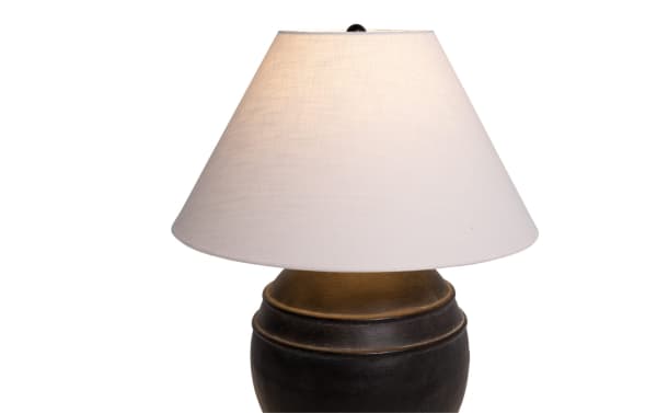 Transitional Laurel Charcoal Table Lamp with round dark gray ceramic base and white fabric shade, ideal for bedside or accent lighting.