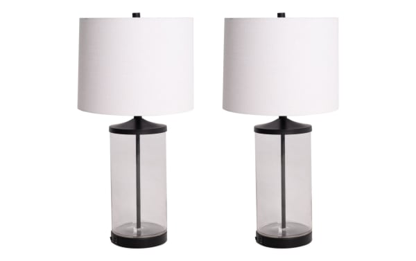 Set of 2 Willow Clear Glass Table Lamps with white fabric drum shades, clear glass cylindrical bases, black metal accents, and built-in USB/USB-C charging ports.