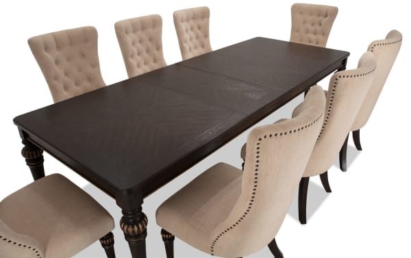 Regency 9 Piece Brown & Beige Upholstered Extendable Dining Set with traditional fluted legs, beige polyester fabric chairs, and oak veneer table.