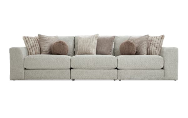 Posh Beige 139'' 3 Piece Modular Sofa in transitional style with plush beige polyester fabric, gel-infused memory foam cushions, and nine decorative pillows.