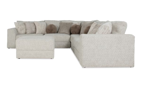 Posh Beige 134" 6-piece modular sectional with plush polyester fabric, 14 accent pillows, storage ottoman, and transitional style upholstery.