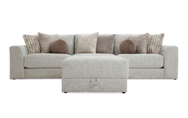 Posh Beige 139'' 4-piece modular sectional with beige polyester fabric upholstery, transitional style, includes 1 armless chair, 1 left arm chair, 1 right arm chair, and a storage ottoman with nine plush accent pillows.
