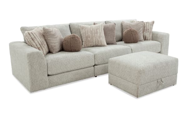 Posh Beige 4-piece modular sectional with plush polyester fabric, transitional style, nine accent pillows, and storage ottoman for living room comfort.