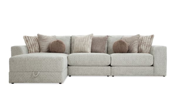 Posh Beige 139" 4-piece modular sectional with beige polyester fabric upholstery, transitional style, includes 1 armless chair, left and right arm facing chairs, storage ottoman, and nine plush accent pillows.