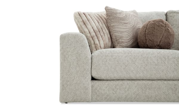 Beige Posh 100'' 4-piece modular loveseat with plush polyester fabric, transitional style, includes 2 ottomans, left and right arm chairs, and multiple accent pillows.