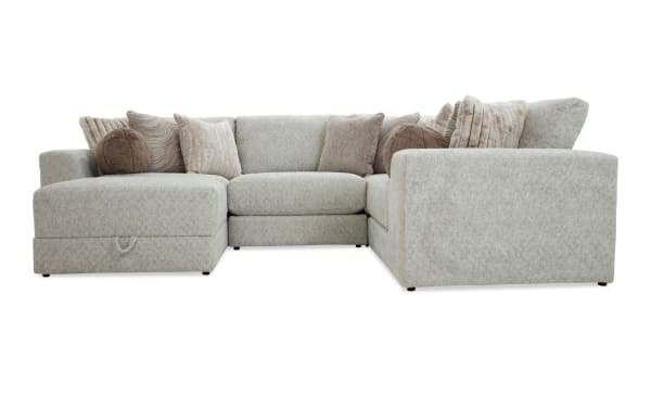 Posh Beige 134'' 4-piece modular sectional with plush polyester fabric upholstery, transitional style, 13 accent pillows, and storage ottoman.