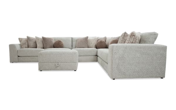 Posh Beige 7-piece modular sectional with plush polyester fabric upholstery, 3 armless chairs, corner, left and right arm facing chairs, and storage ottoman. Transitional style with 15 beige accent pillows and gel-infused memory foam cushions for ultimate comfort.