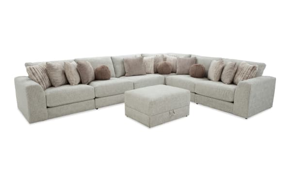 Posh Beige 7-piece modular sectional sofa with plush polyester fabric, 15 accent pillows, gel-infused memory foam cushions, and storage ottoman.