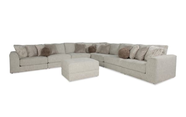 Posh Beige 172" 8-piece modular sectional in transitional style with plush beige polyester fabric, 16 accent pillows, and storage ottoman.