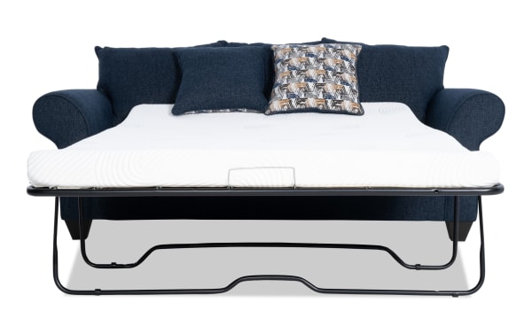 Kylie Navy 92'' transitional sleeper sofa in blue polyester fabric with rolled arms, accent pillows, and pull-out queen gel memory foam mattress.