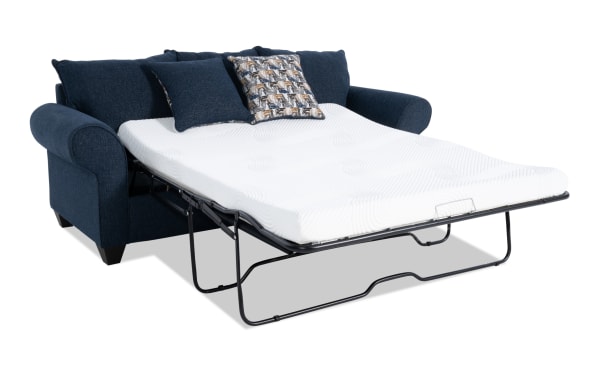 Kylie Navy 92'' transitional sleeper sofa in blue polyester fabric with rolled arms, pull-out queen gel memory foam mattress, and accent pillows.