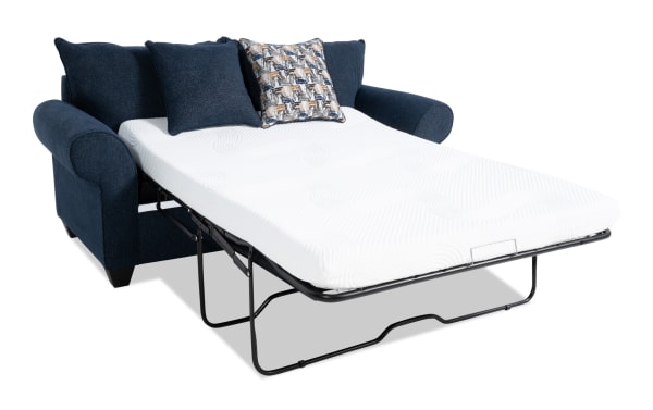 Kylie Navy 82'' transitional sleeper sofa in blue polyester fabric with rolled arms, pull-out full gel mattress, and decorative accent pillows.