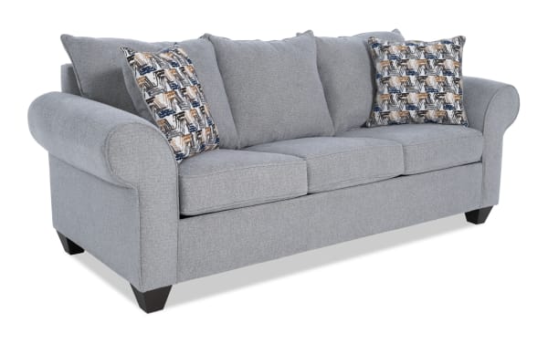 Kylie Gray 92'' transitional sleeper sofa in gray polyester fabric with rolled arms, three seat cushions, patterned accent pillows, and queen cooling gel memory foam mattress.