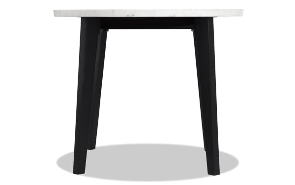Round counter-height dining table from the Elm Dining collection featuring a white marble top and black tapered legs in transitional style.
