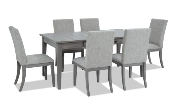 Homeworks 7 Piece Gray Upholstered Dining Set with melamine table, lift-top storage, felt-lined drawers, and six gray fabric chairs with memory foam seats.