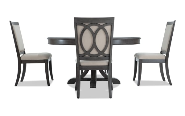 Contemporary Coco II 5 Piece Dining Set with oval gray Asian hardwood table, beige polyester-upholstered chairs, and cherry veneer accents.