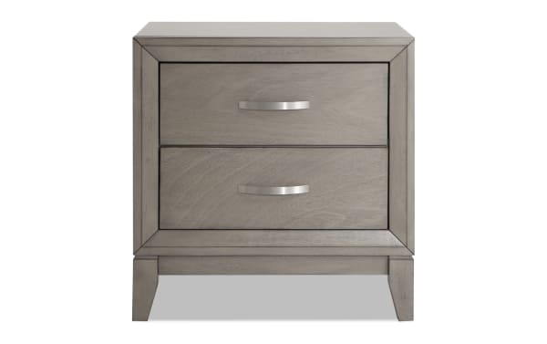Gray Tremont transitional nightstand with two storage drawers, polyester fabric upholstery, MDF and rubberwood frame, part of a 4-piece bedroom set.