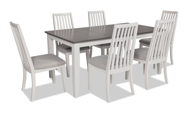 Blake 7 Piece White & Gray Upholstered Dining Set with six gray fabric cushioned slat-back chairs and extendable gray tabletop. Transitional style with MDF, hardwood, rubberwood, and birch veneers.